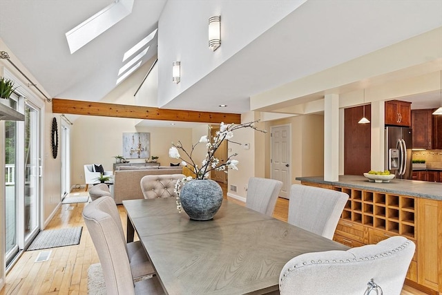12 Green Needles Rd, Littleton, MA 01460 - dining space featuring a skylight, light wood-style flooring, and a high ceiling