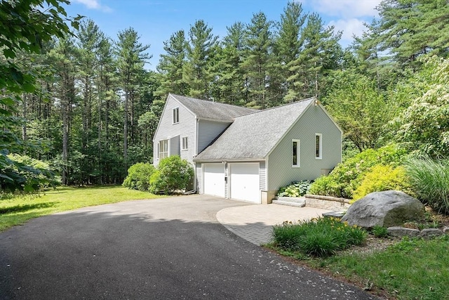 12 Green Needles Rd, Littleton, MA 01460 - view of property exterior featuring an attached garage, asphalt driveway, roof with shingles, and a lawn