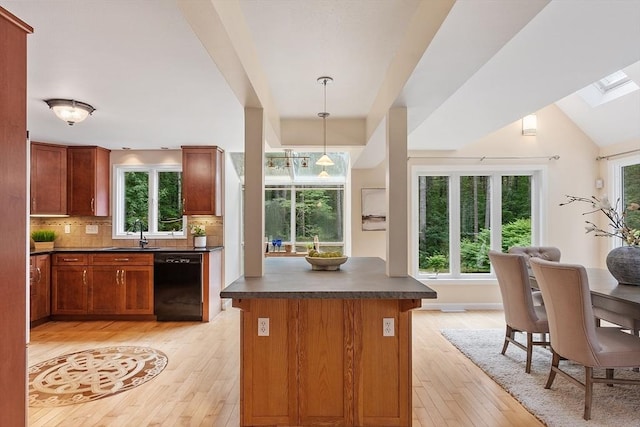 12 Green Needles Rd, Littleton, MA 01460 - kitchen featuring dishwasher, dark countertops, light wood-style flooring, tasteful backsplash, and a skylight