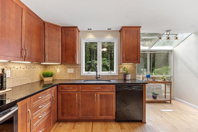 12 Green Needles Rd, Littleton, MA 01460 - kitchen featuring black dishwasher, light wood finished floors, backsplash, and brown cabinets