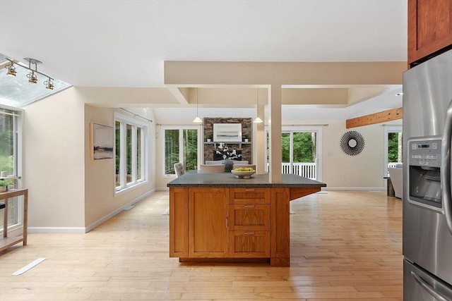 12 Green Needles Rd, Littleton, MA 01460 - kitchen with stainless steel refrigerator with ice dispenser, dark countertops, light wood-style flooring, a kitchen island, and brown cabinetry