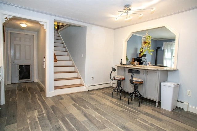 bar with baseboard heating, a baseboard heating unit, stairway, wood finished floors, and ornamental molding