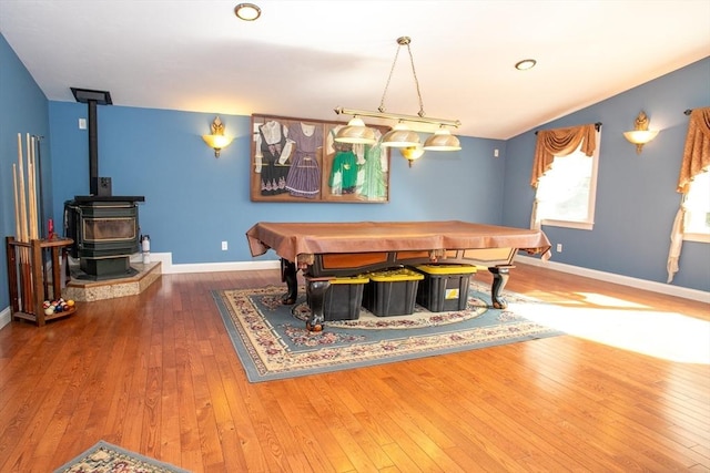 game room with hardwood / wood-style floors, baseboards, a wood stove, and billiards