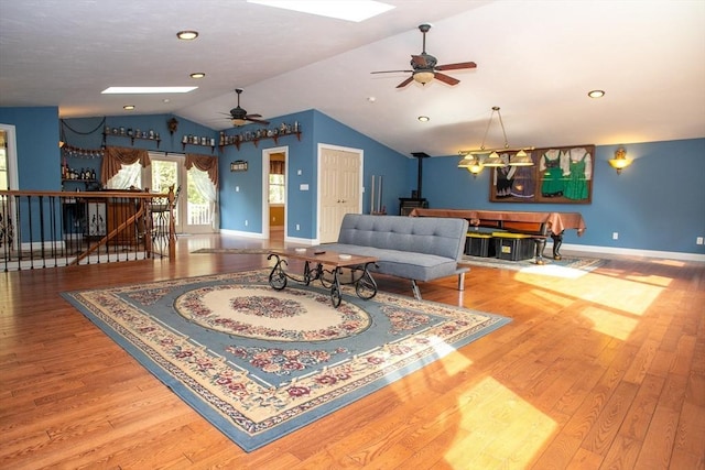 living room with lofted ceiling, a ceiling fan, and wood finished floors