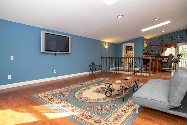 living room with vaulted ceiling, wood finished floors, baseboards, and recessed lighting