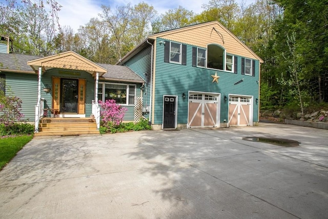 view of front of home with concrete driveway and an attached garage