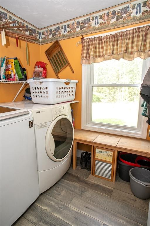 laundry room featuring washing machine and dryer and wood finished floors