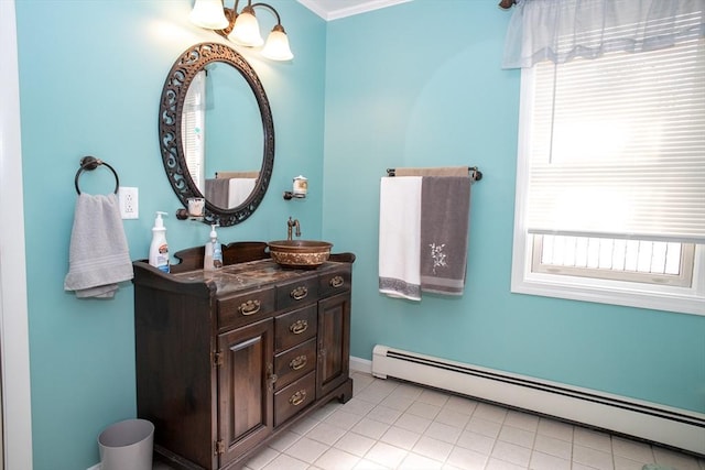 bathroom featuring baseboard heating, ornamental molding, vanity, baseboards, and tile patterned flooring