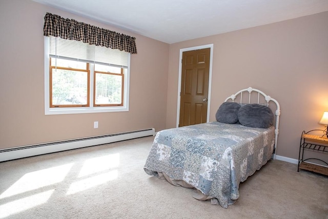 bedroom with carpet, baseboard heating, and baseboards