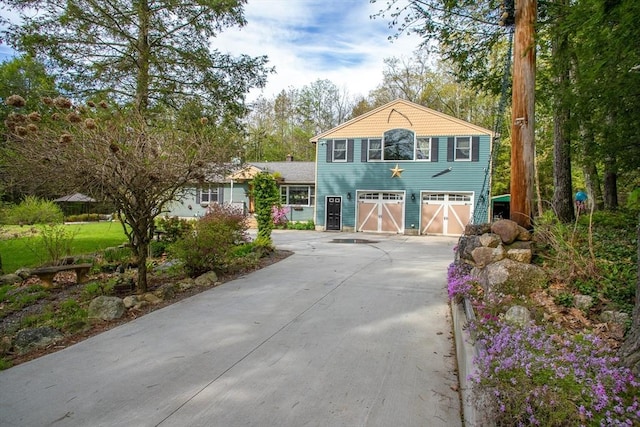 view of front of property with concrete driveway and a garage