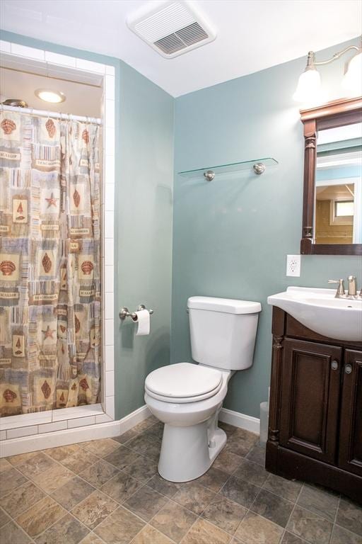 bathroom featuring baseboards, toilet, and a shower with shower curtain