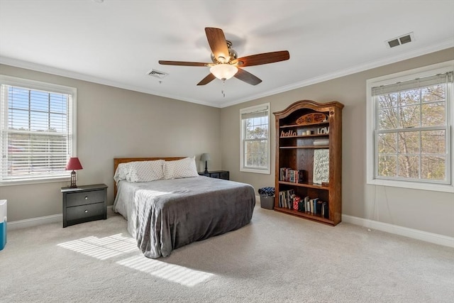 bedroom featuring baseboards, ornamental molding, carpet flooring, and visible vents