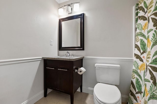 bathroom with vanity, baseboards, and toilet