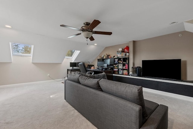 carpeted living room featuring a ceiling fan, baseboards, recessed lighting, and vaulted ceiling with skylight