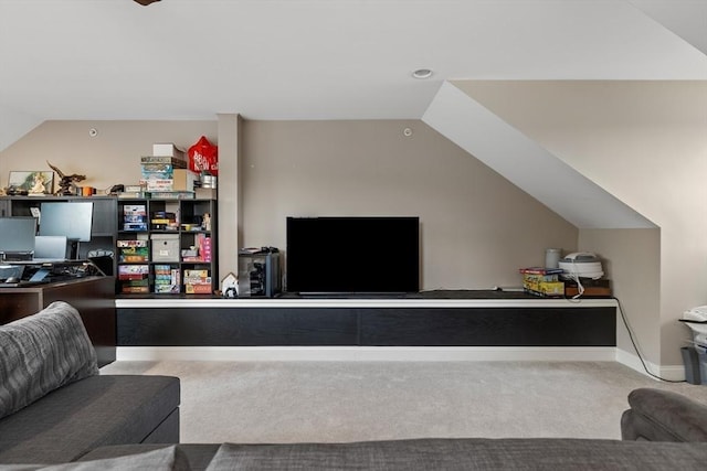 carpeted living area with baseboards and lofted ceiling