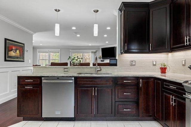 kitchen with decorative light fixtures, light stone countertops, dishwasher, a sink, and ornamental molding