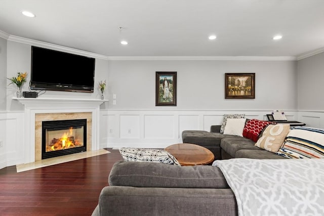 living area featuring ornamental molding, wainscoting, a decorative wall, wood finished floors, and recessed lighting