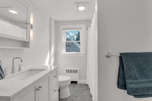bathroom with radiator, baseboards, vanity, and toilet