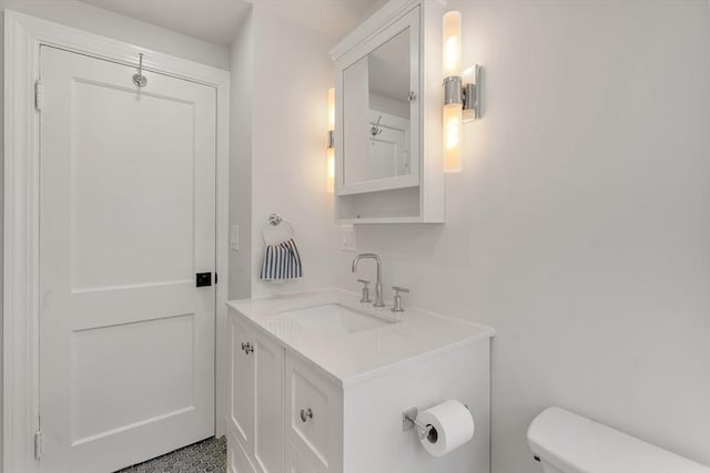 bathroom with toilet and vanity