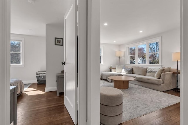 living area featuring recessed lighting, baseboards, and dark wood finished floors