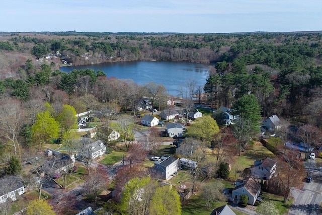 birds eye view of property with a water view and a wooded view