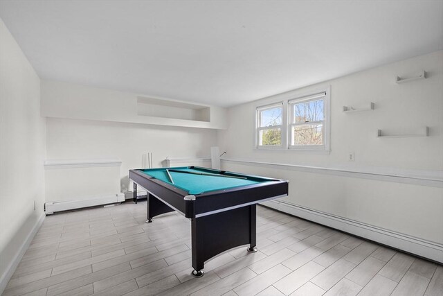 recreation room with billiards, a baseboard radiator, baseboards, and wood finished floors