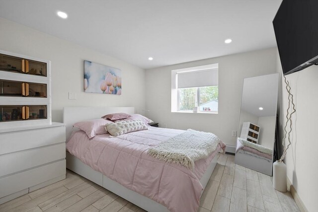 bedroom with recessed lighting, baseboards, and light wood finished floors