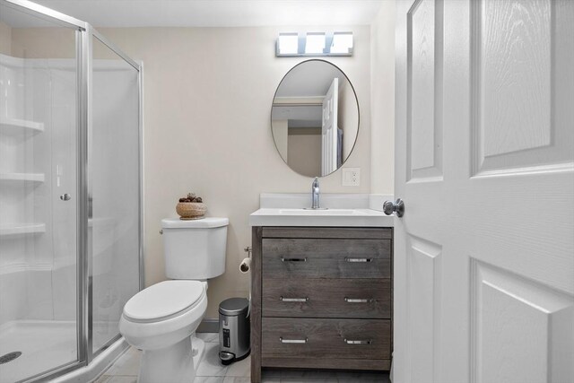 bathroom featuring vanity, toilet, and a shower stall