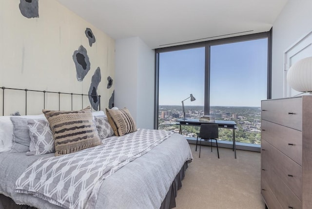 bedroom featuring multiple windows, light carpet, and a wall of windows