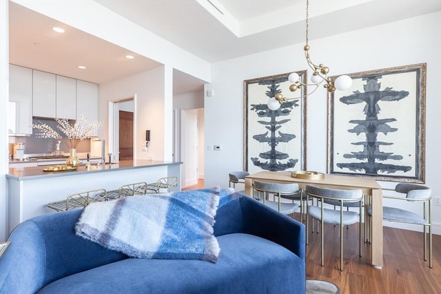 living room featuring dark wood-type flooring and a notable chandelier