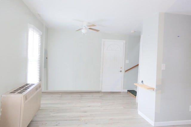 empty room featuring ceiling fan and light hardwood / wood-style floors