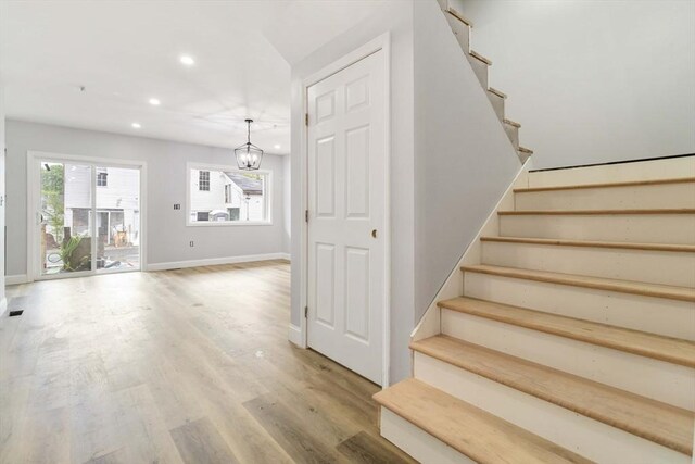 43 Pine St, Taunton, MA 02780 - stairs with recessed lighting, wood finished floors, a chandelier, and baseboards