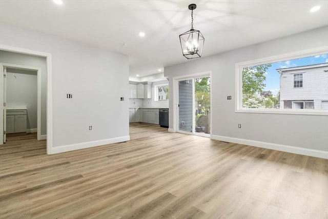 43 Pine St, Taunton, MA 02780 - unfurnished living room with recessed lighting, baseboards, light wood-type flooring, and a chandelier
