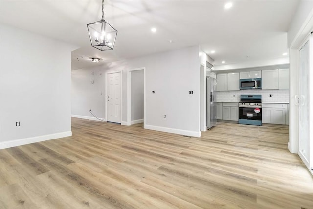 43 Pine St, Taunton, MA 02780 - unfurnished living room featuring recessed lighting, baseboards, light wood finished floors, and a chandelier