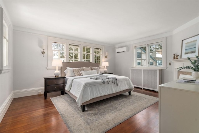 bedroom featuring radiator, dark wood-type flooring, and a wall mounted air conditioner