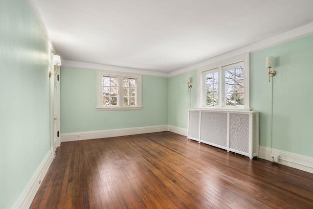 unfurnished room with dark wood-type flooring and radiator