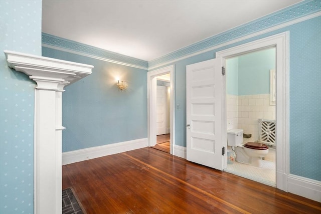 spare room with ornamental molding and hardwood / wood-style floors