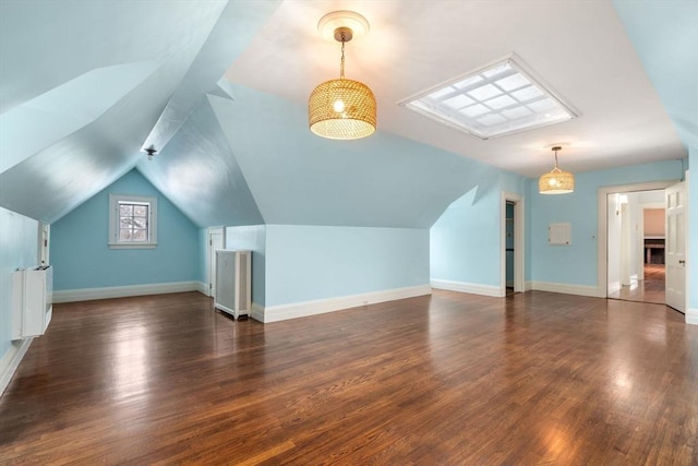 additional living space featuring lofted ceiling and dark hardwood / wood-style floors