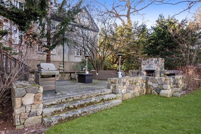 view of yard featuring a patio area and an outdoor stone fireplace