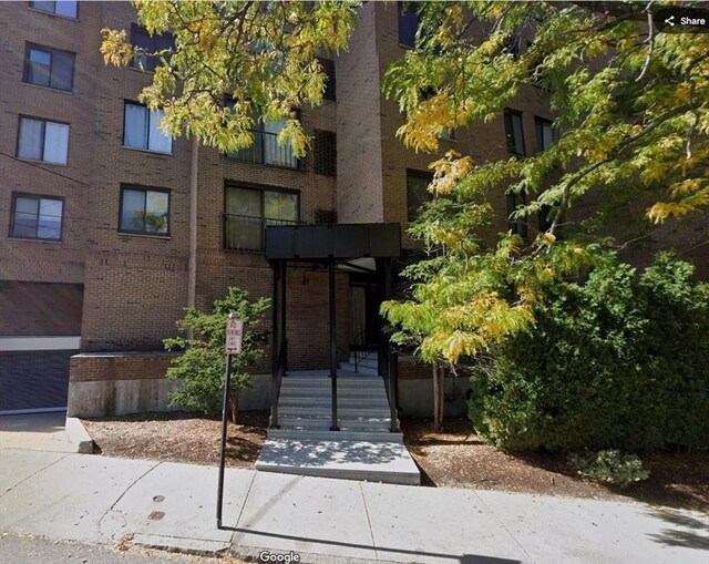 exterior space featuring brick siding