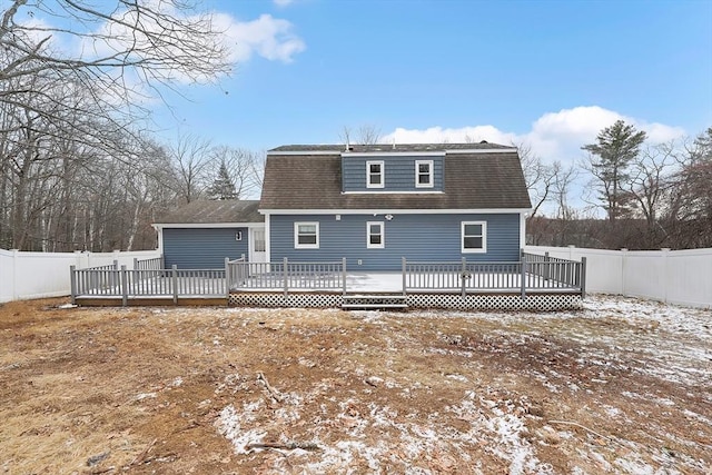 snow covered property with a wooden deck