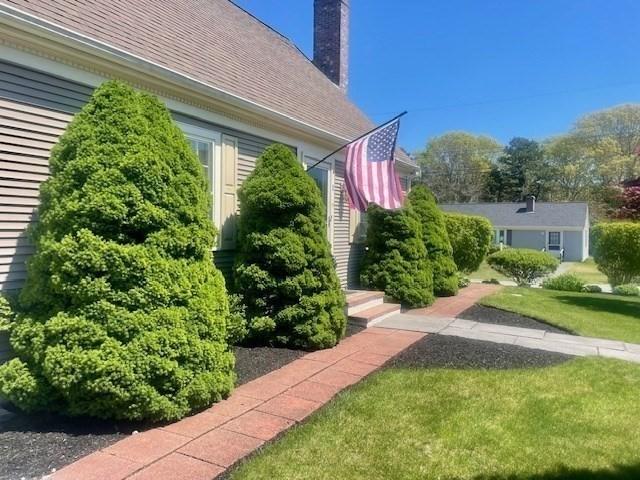 2 Spinning Brook Rd, Yarmouth, MA 02664 - view of side of property featuring a yard and a chimney