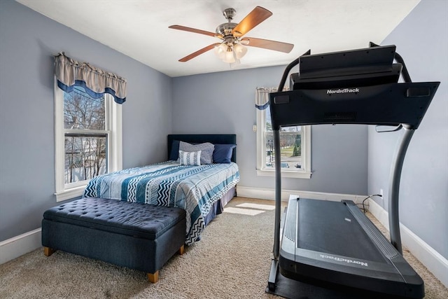 carpeted bedroom with baseboards and ceiling fan
