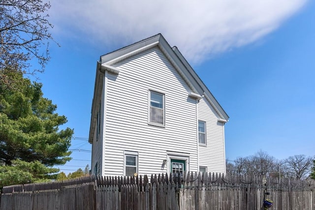 view of side of home with fence