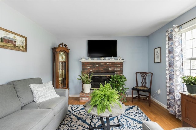 33 Cranberry Rd, Whitman, MA 02382 - living area with light wood finished floors, a fireplace, and baseboards