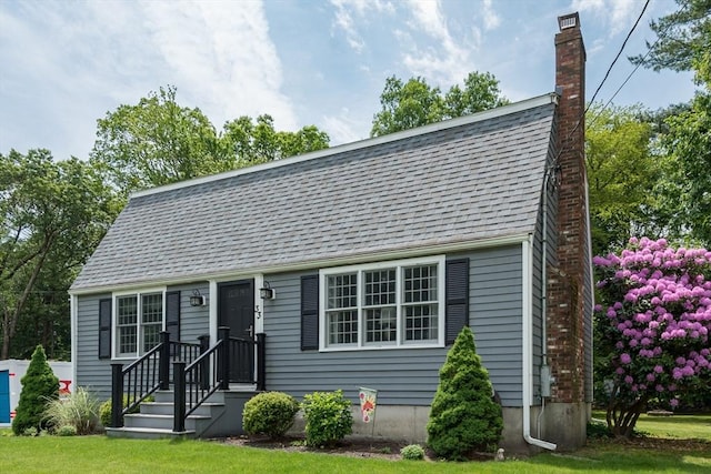 33 Cranberry Rd, Whitman, MA 02382 - colonial inspired home with a chimney, a front yard, and roof with shingles