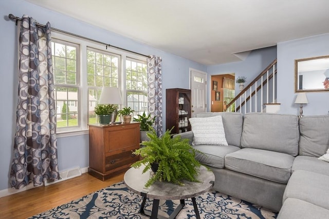 33 Cranberry Rd, Whitman, MA 02382 - living area with light wood-style floors, plenty of natural light, stairway, and baseboards