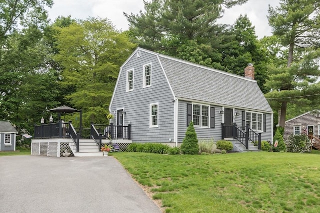 33 Cranberry Rd, Whitman, MA 02382 - dutch colonial featuring a shingled roof, a front lawn, a chimney, a deck, and view of scattered trees