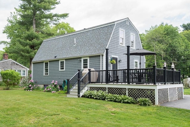 33 Cranberry Rd, Whitman, MA 02382 - rear view of house featuring a yard, a wooden deck, a shingled roof, and a gambrel roof