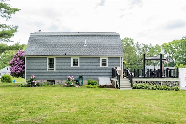 33 Cranberry Rd, Whitman, MA 02382 - rear view of property featuring roof with shingles, a deck, and a lawn